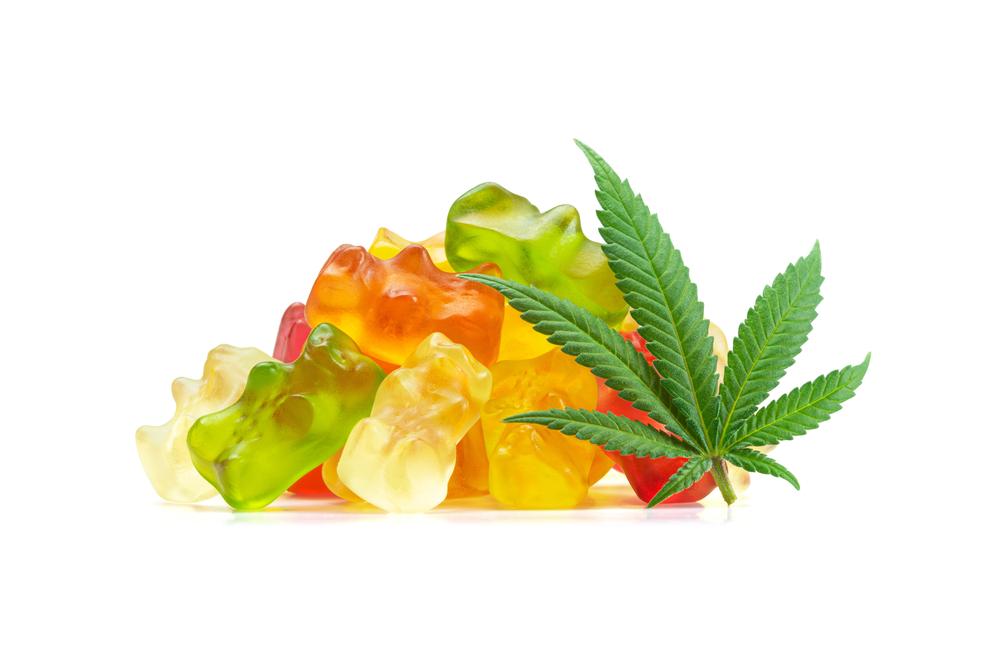 An image of a marijuana leaf and marijuana edibles